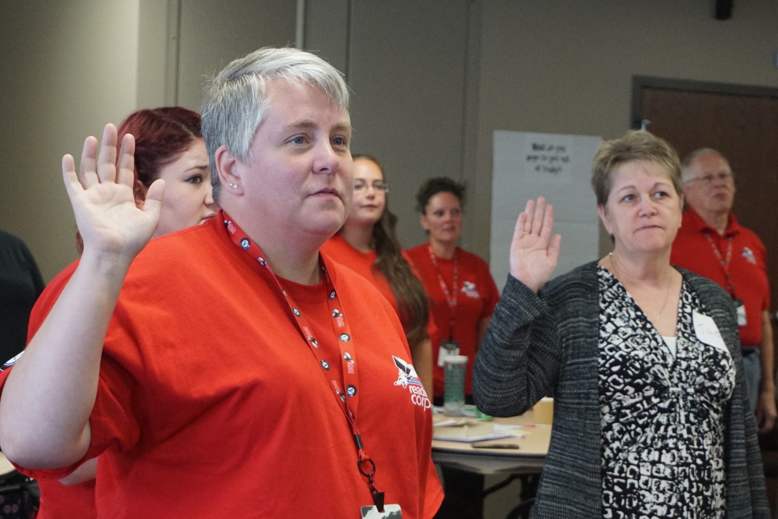 Rochester members raise their right hands as they take the AmeriCorps pledge