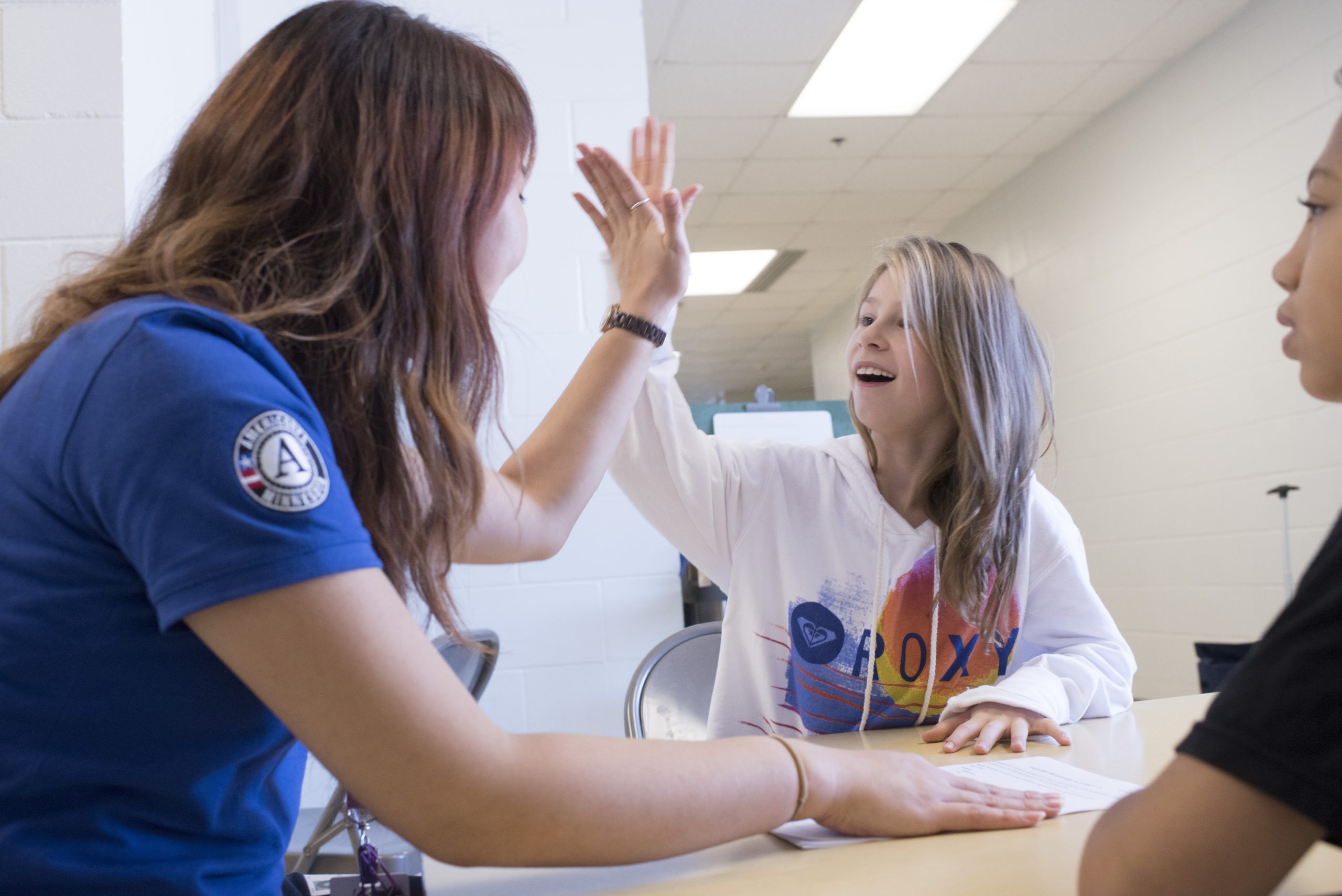 Math Corps tutor giving female student a high-five