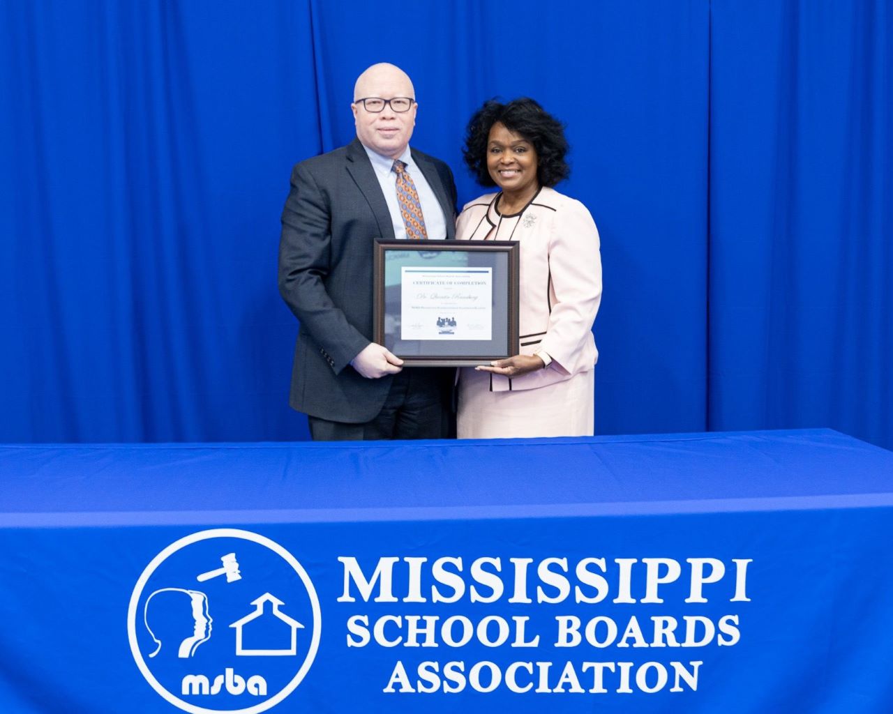 Dr. Quentin Ransburg receives his graduation diploma from the 2023 Mississippi Perspective Superintendent Leadership Academy.