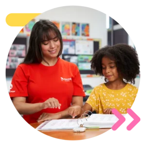 Young female reading tutor leading a student through a reading intervention.